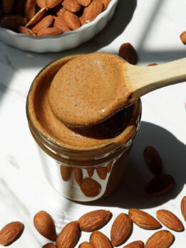 Creamy homemade almond butter in a glass jar.