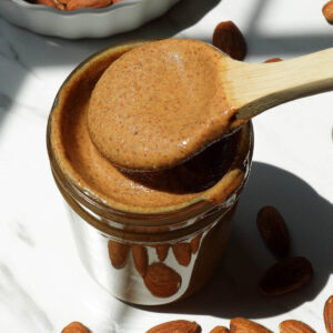 Creamy homemade almond butter in a glass jar.