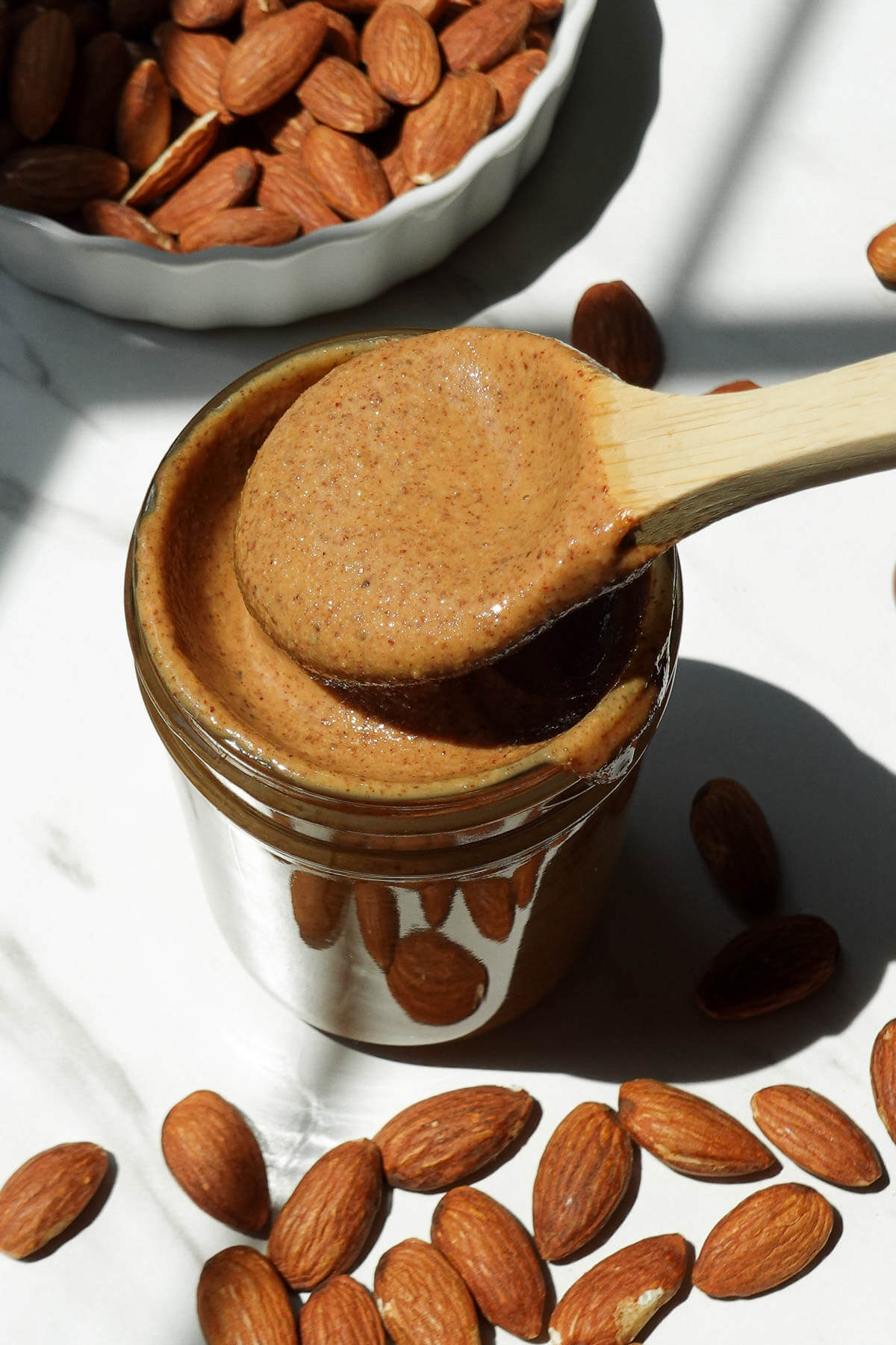 Creamy homemade almond butter in a glass jar.