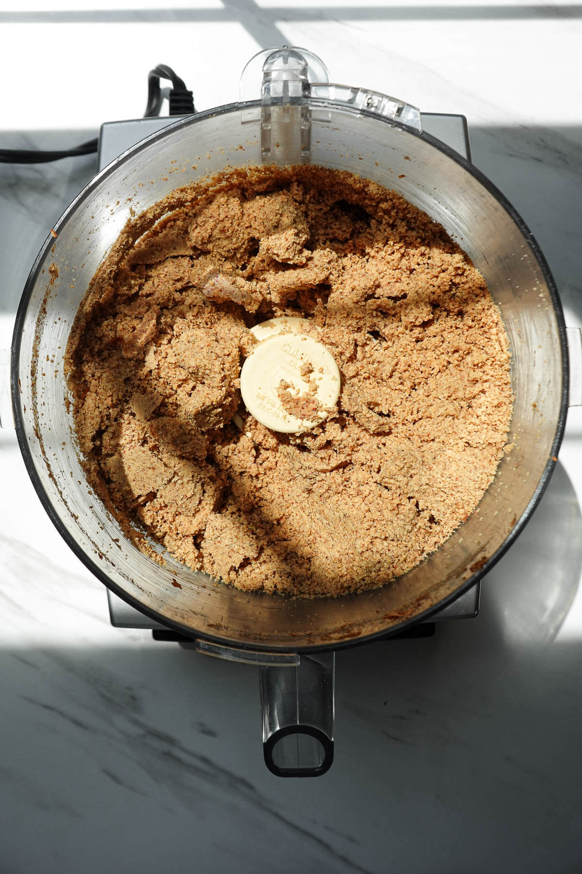 Roasted almonds in the crumbly stage while blending into almond butter.