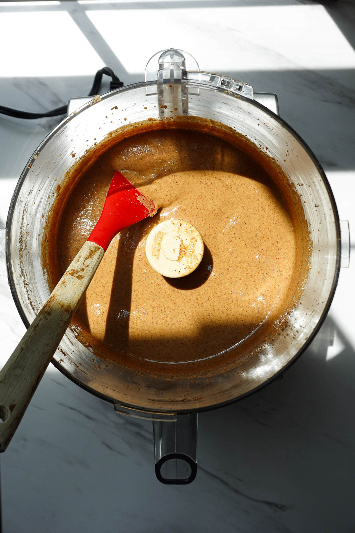 Creamy almond butter in a food processor.