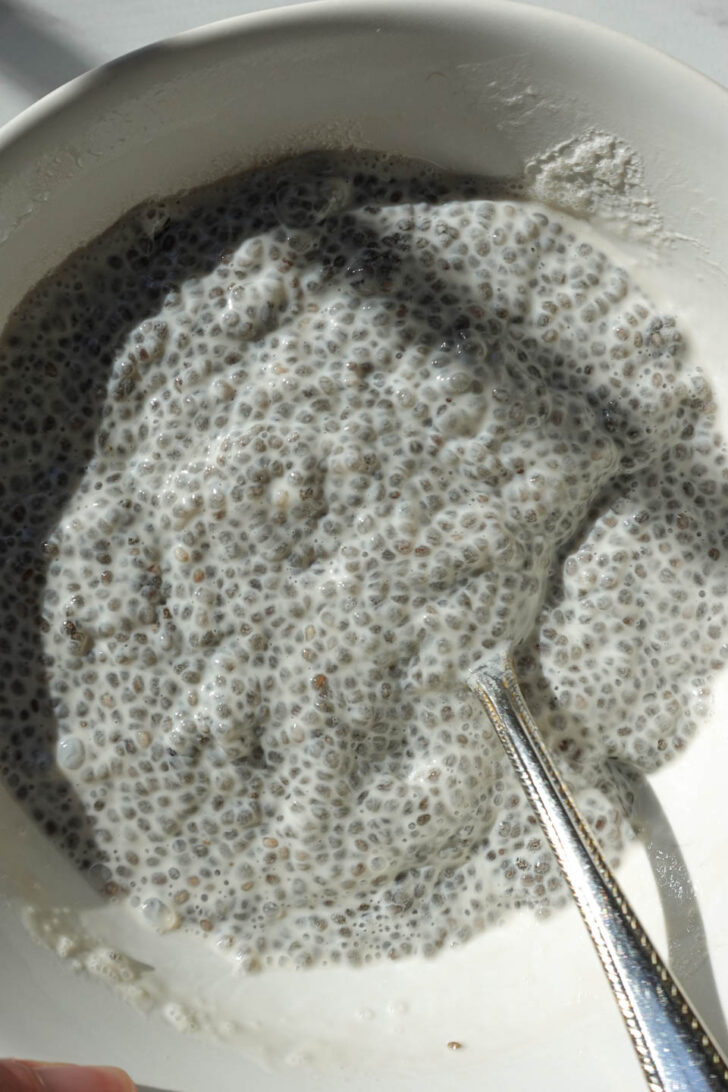 chia seed pudding mixture thickening in a bowl