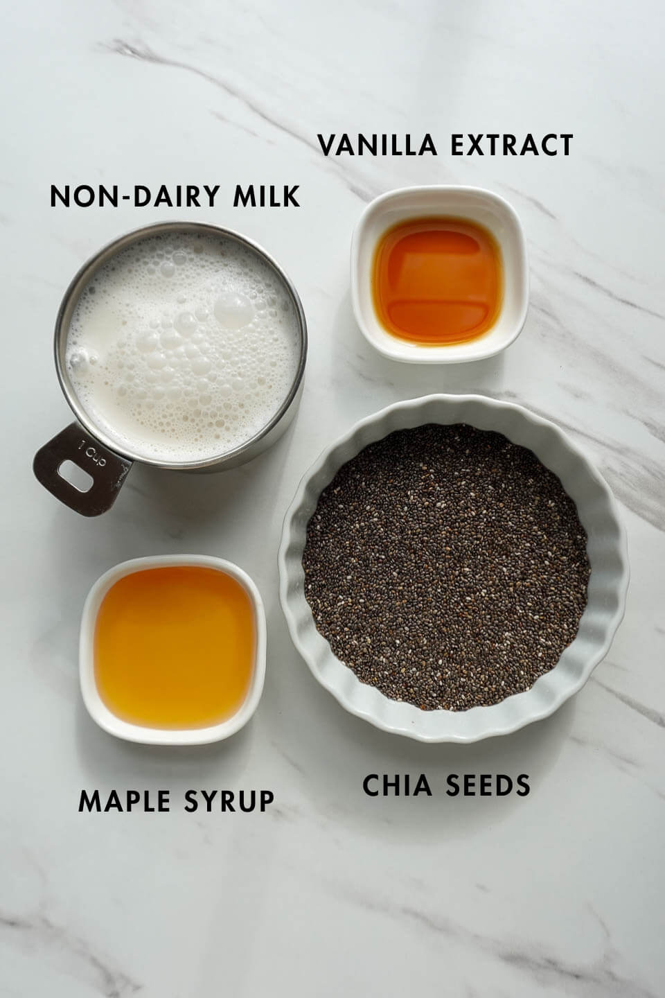 ingredients for chia pudding recipe: chia seeds, non-dairy milk, maple syrup and vanilla extract