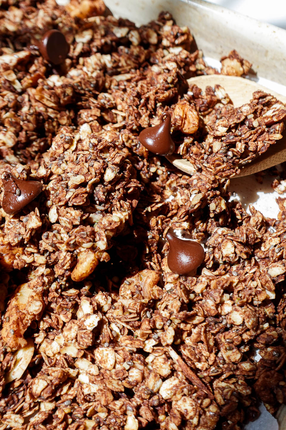 Crunchy homemade chocolate granola with oats and nuts on a baking sheet