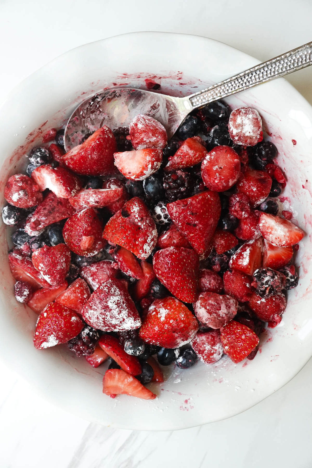 Tossing berries in cornstarch.