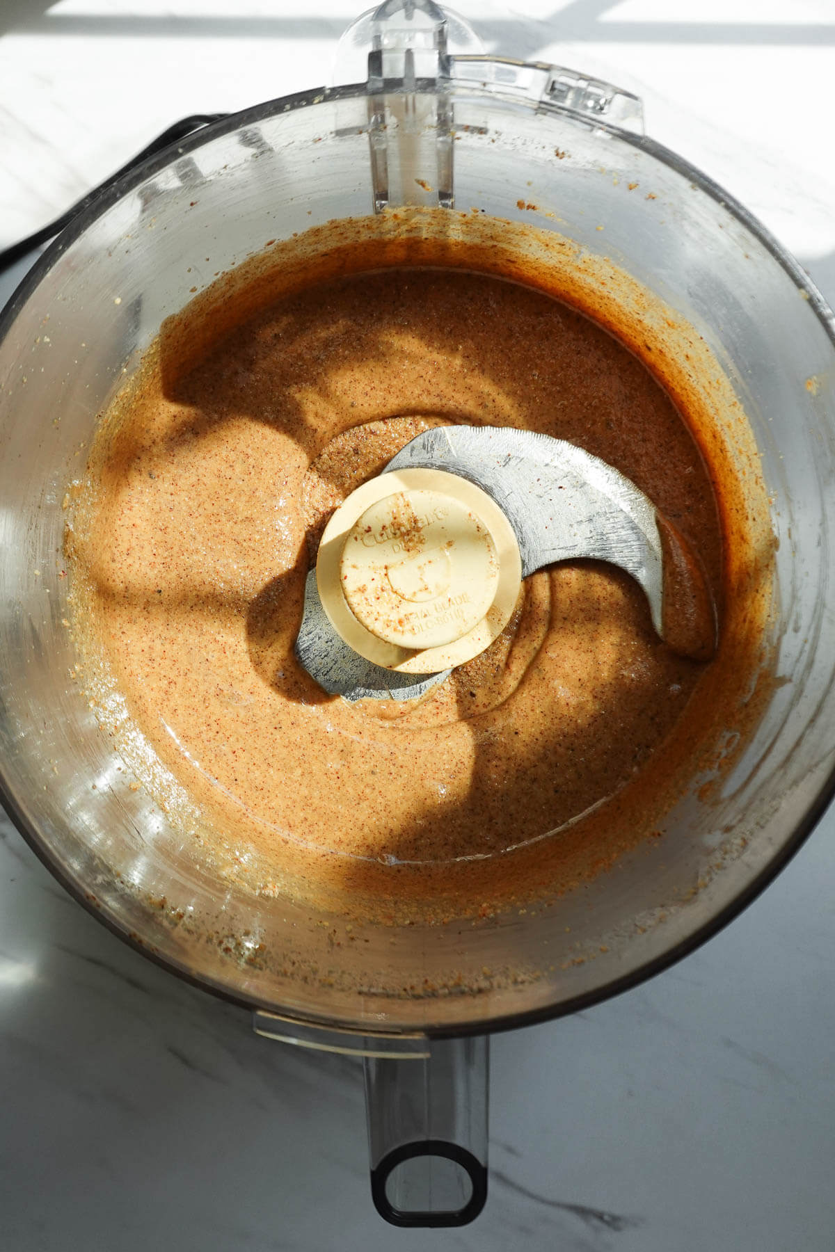 Smooth and creamy homemade hazelnut butter in a food processor.