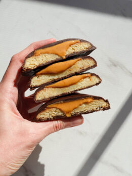 stack of homemade vegan and gluten-free Tagalongs with creamy peanut butter oozing out