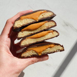 stack of homemade vegan and gluten-free Tagalongs with creamy peanut butter oozing out