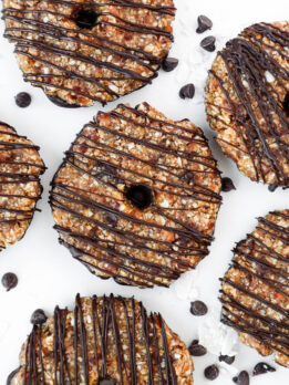 A plate of vegan Samoas cookies with a dark chocolate drizzle