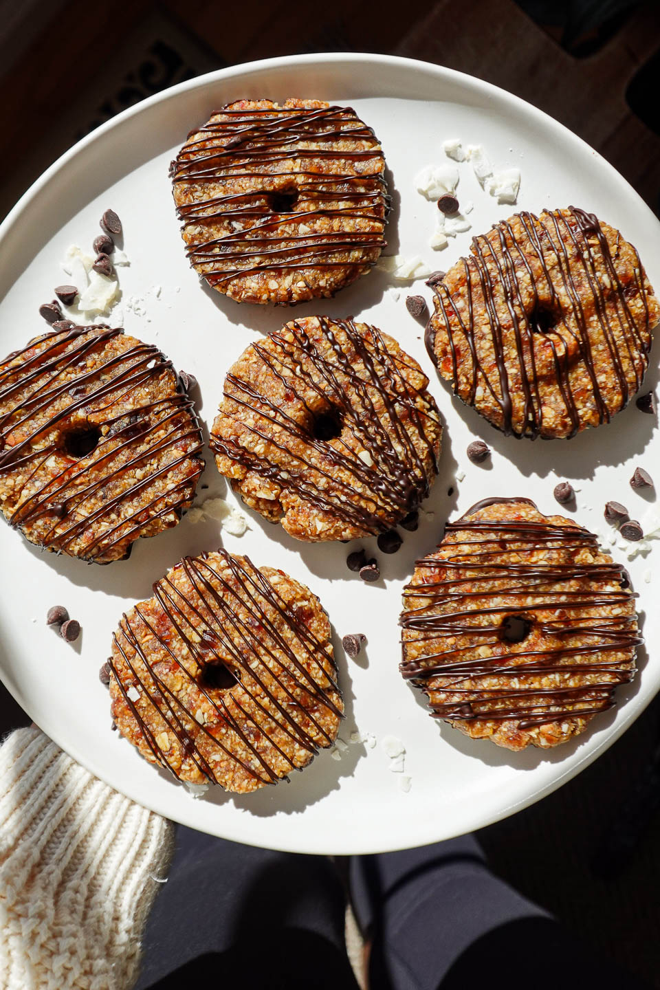 A plate of vegan samoas cookies with a dark chocolate drizzle