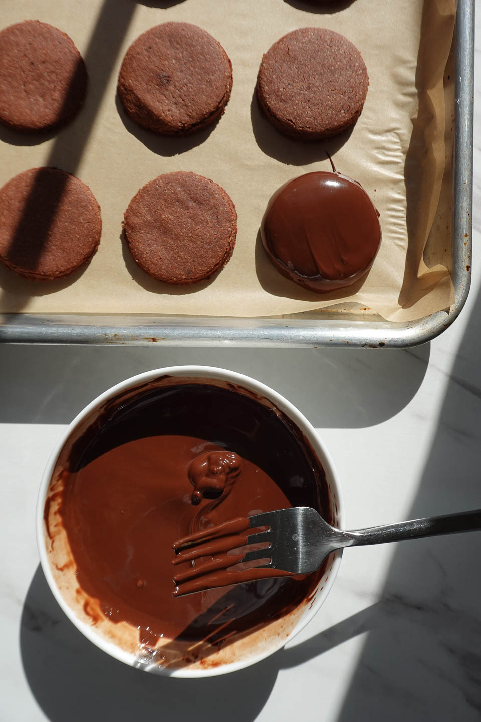 dipping homemade Thin Mints in melted chocolate
