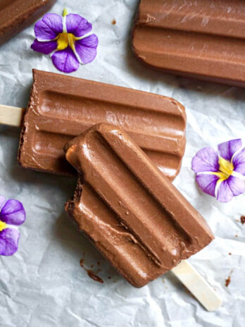 Close-up of a homemade vegan fudgesicle with a bite taken out of the top.