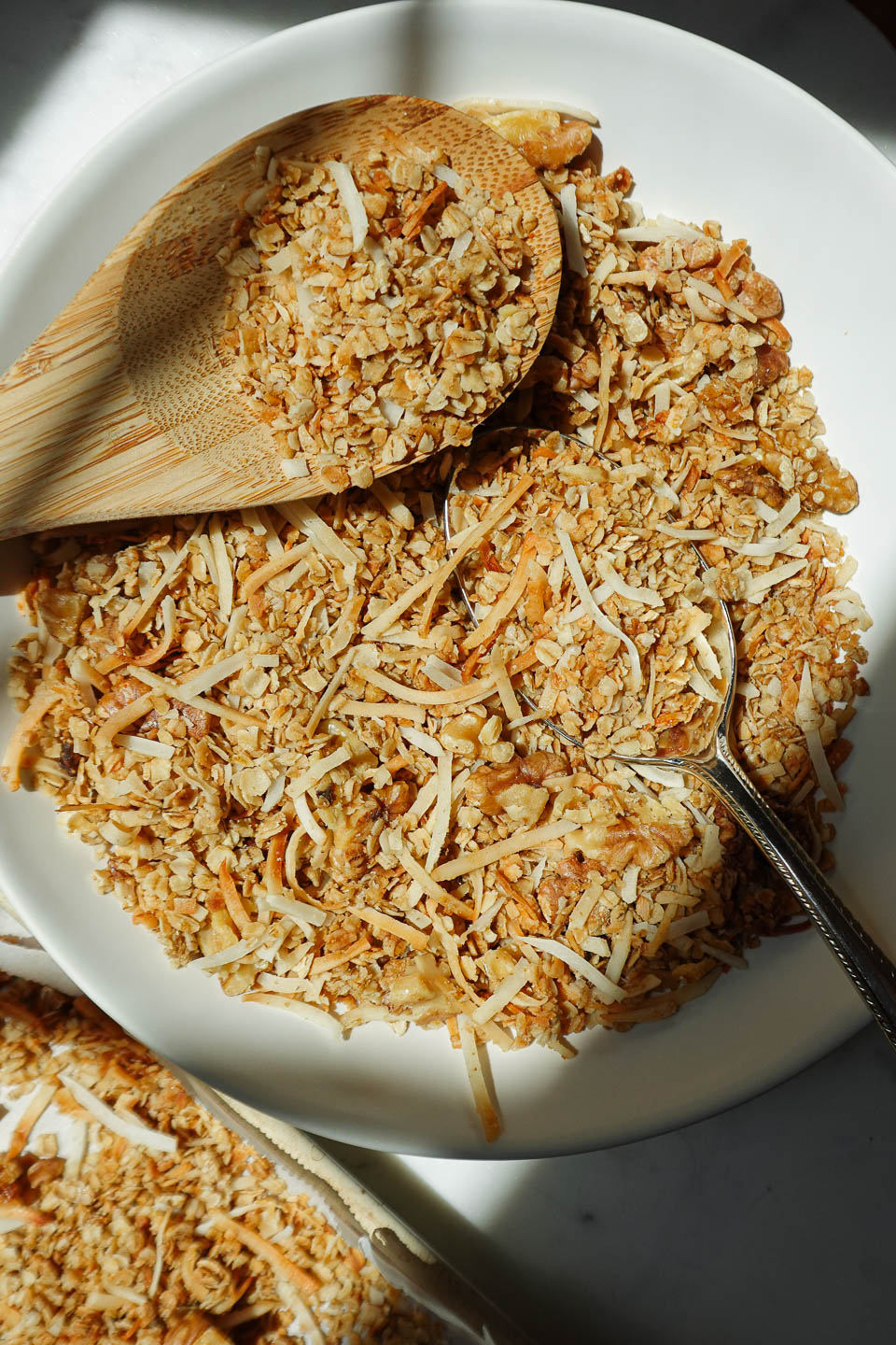 healthy homemade granola in a bowl with a wooden spoon, only 5 ingredients