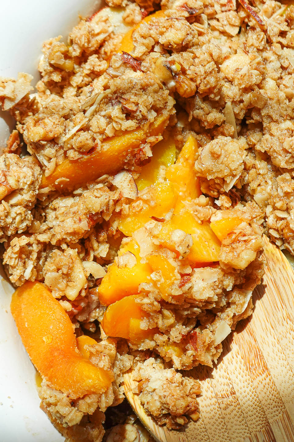 Freshly baked peach crisp with bubbling fruit and golden topping.
