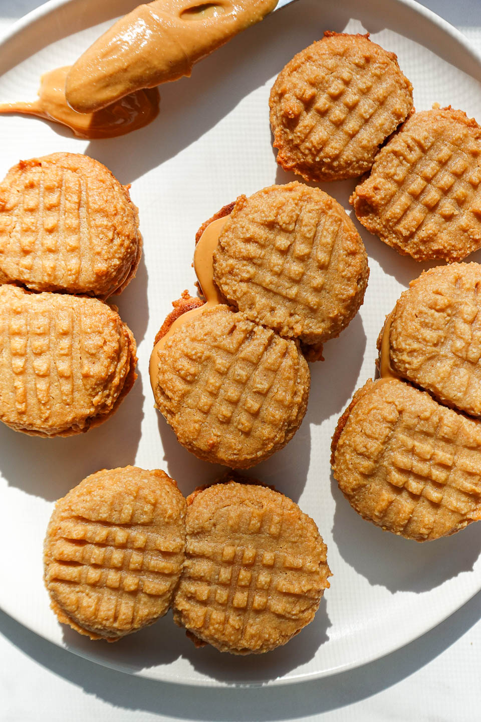 homemade nutter butter cookies with peanut butter filling on a plate