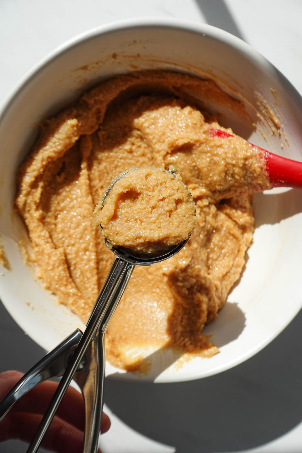 scooping cookie dough for nutter butters