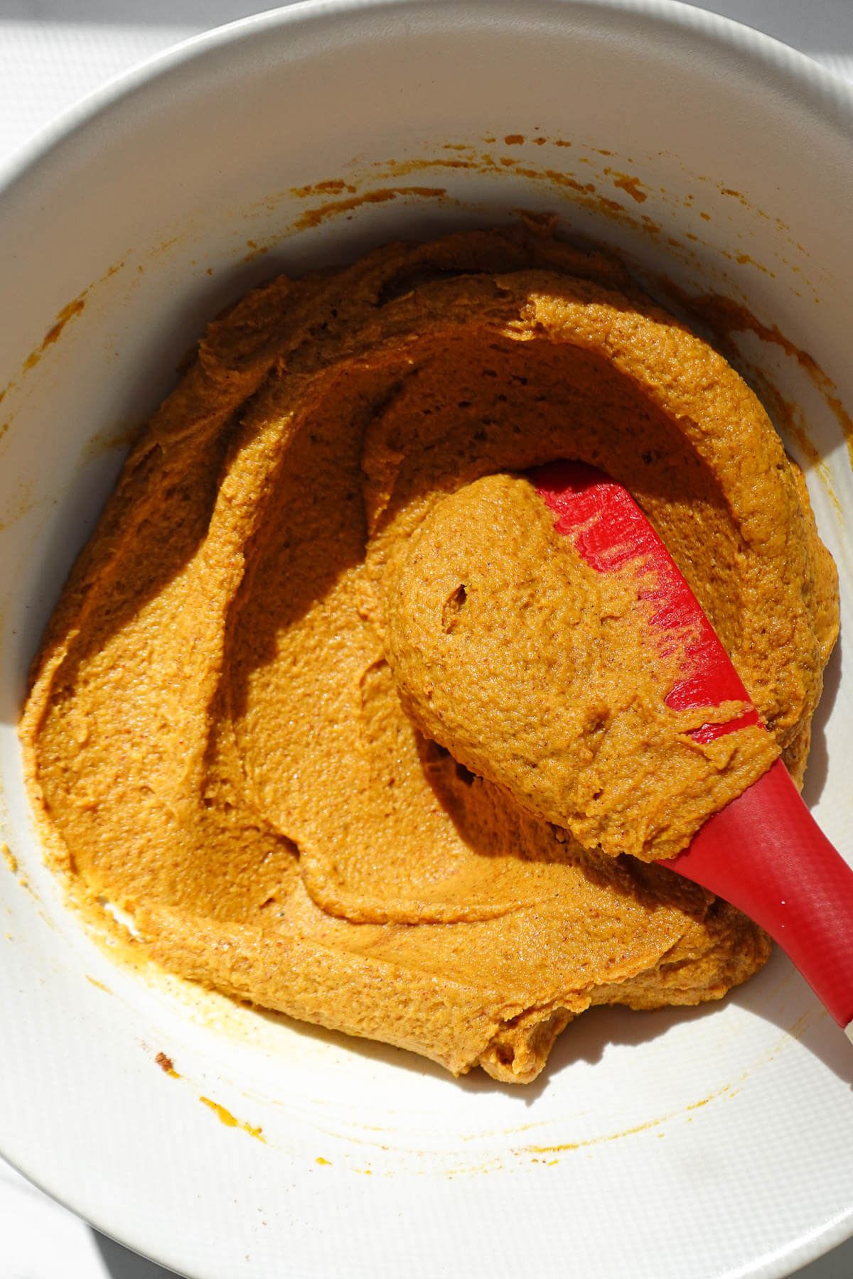Mixing filling to make pumpkin peanut butter cups.