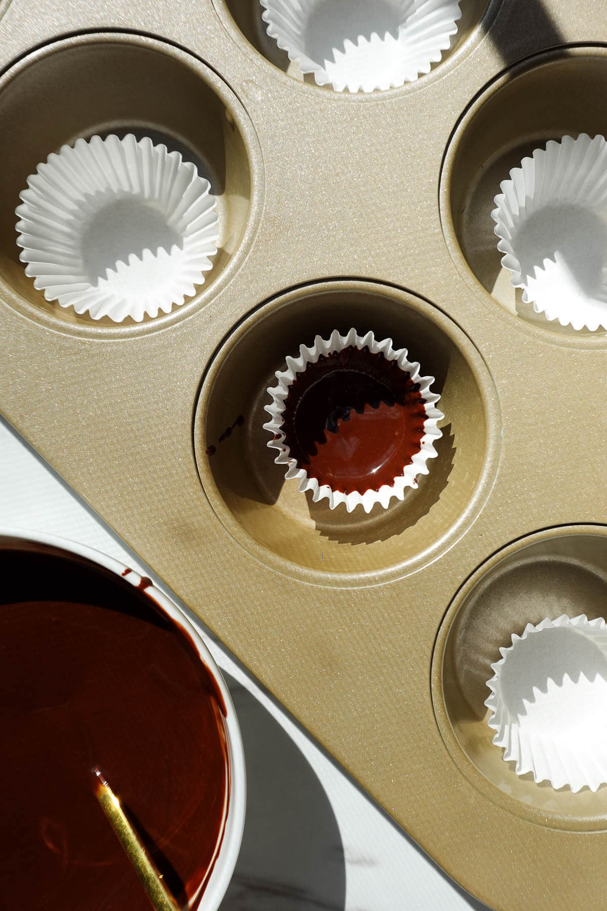 Making chocolate shell to fill pumpkin peanut butter cups.