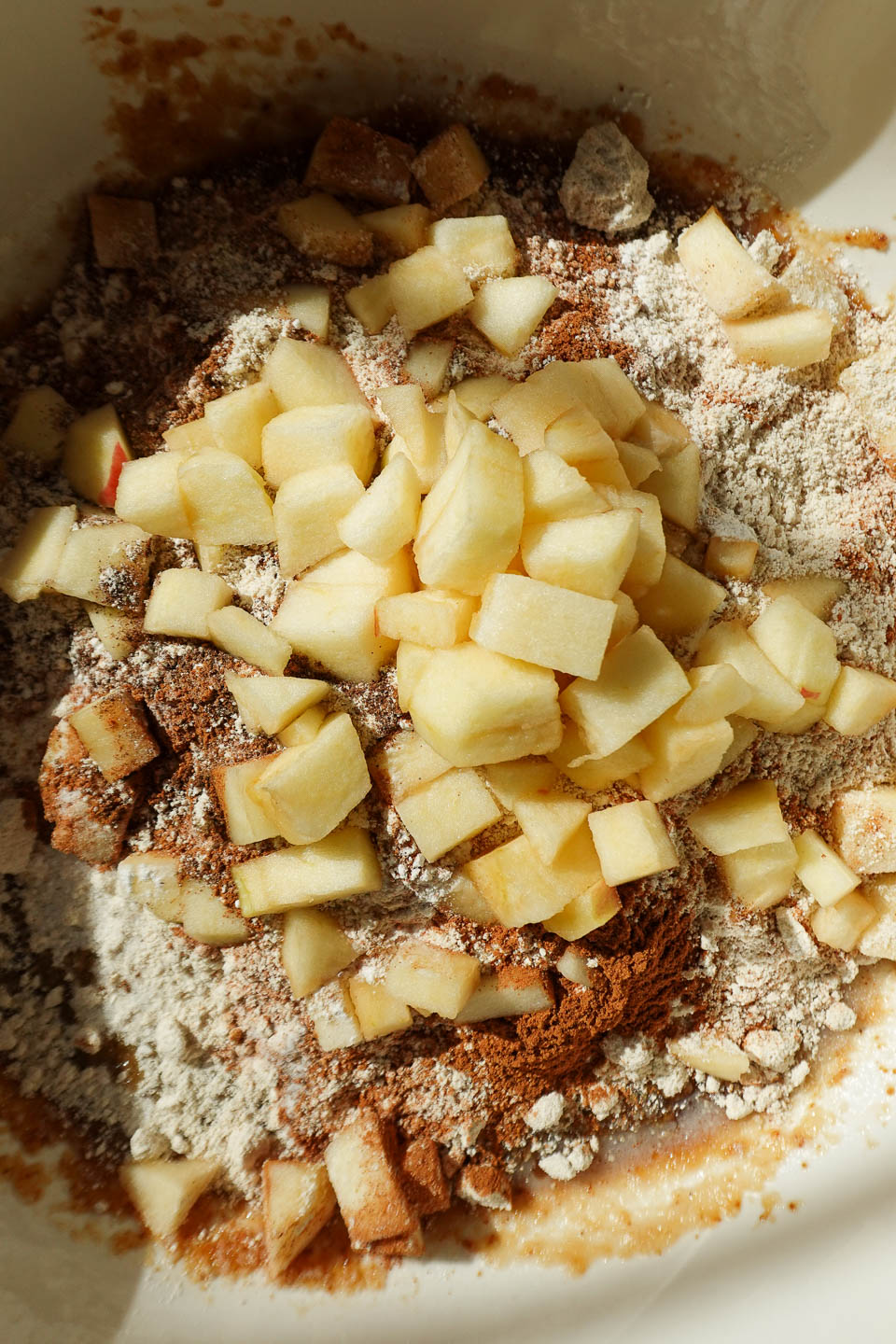 Folding apple chunks into apple bread batter