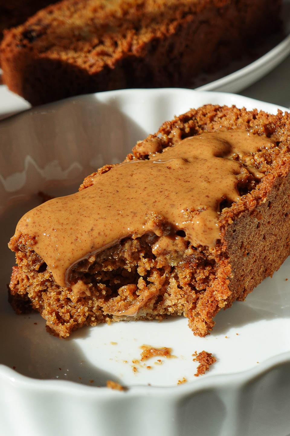 Close up of apple bread slice showing tender crumb and chunks of apple