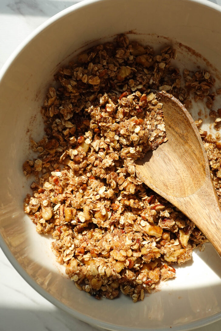 Crisp topping mixed with almond flour, nuts, maple syrup, and melted vegan butter.