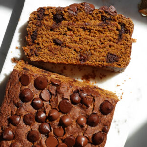 Slice of vegan pumpkin bread on a marble plate.