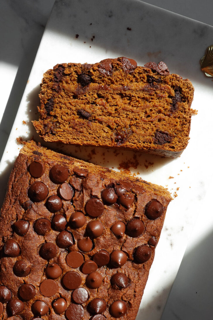 Slice of vegan pumpkin bread on a marble plate.