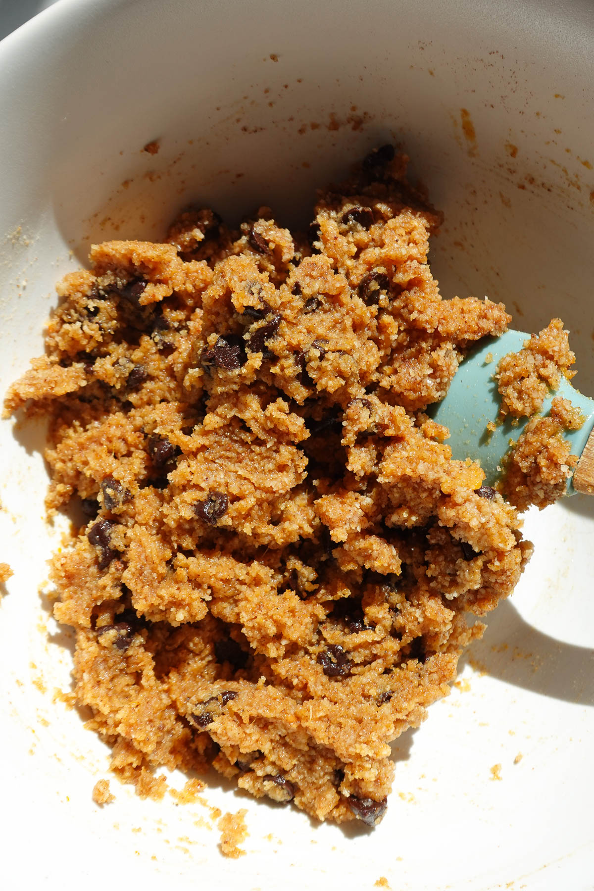 Mixing ingredients together to make edible pumpkin cookie dough.