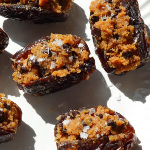 Pumpkin stuffed dates filled with pumpkin cookie dough and topped with chocolate chips.