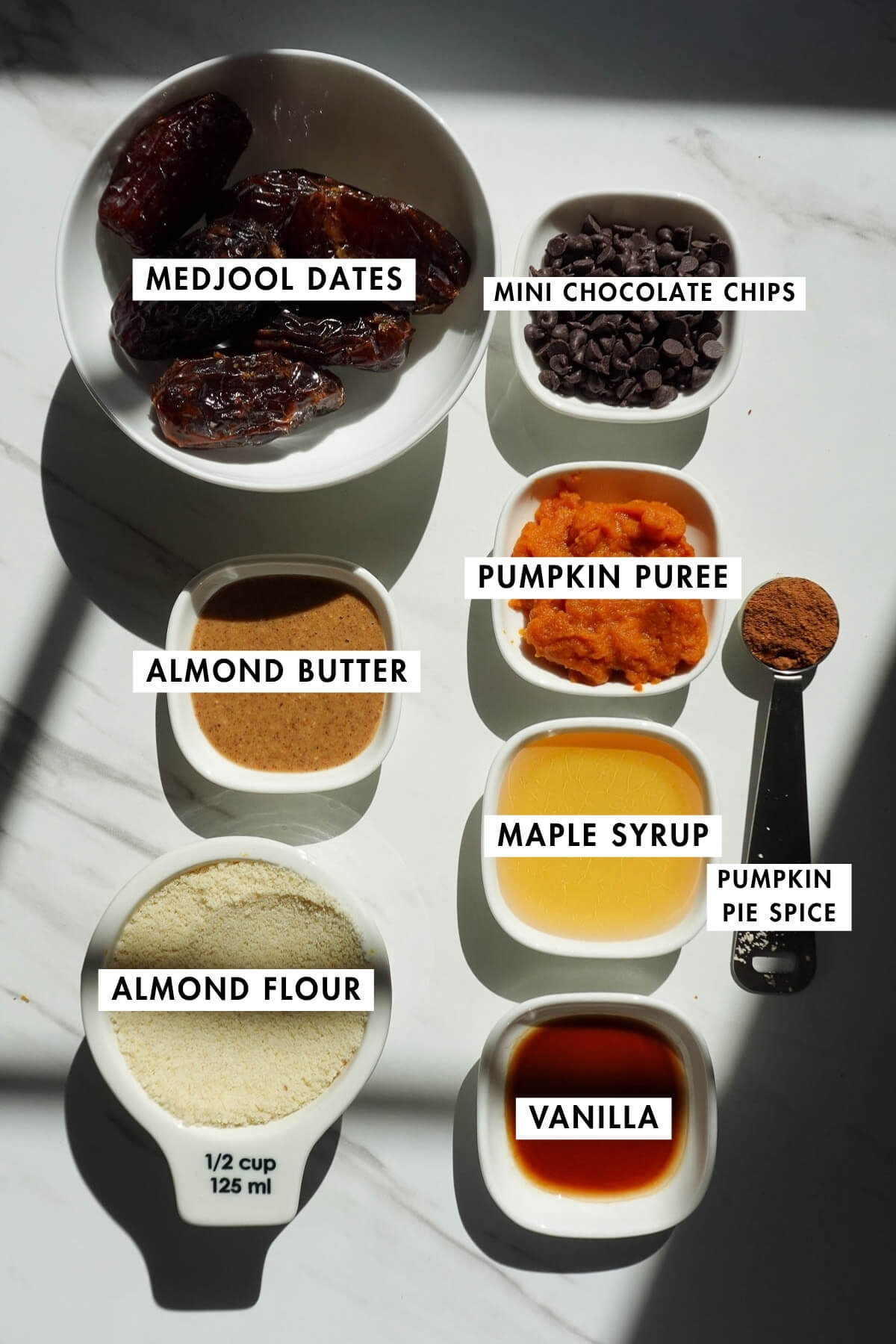 Measured ingredients needed to make pumpkin cookie dough stuffed dates.