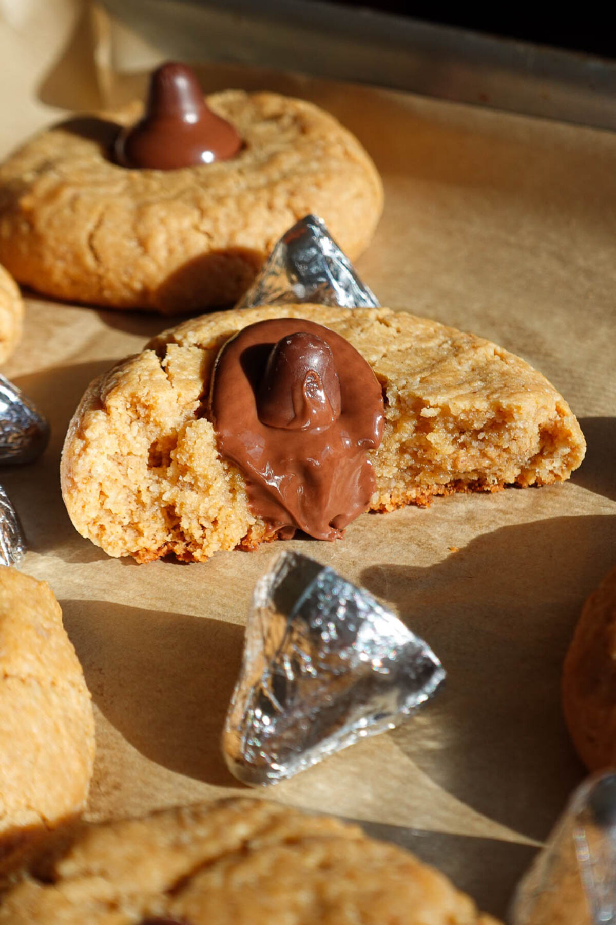 soft and chewy peanut butter blossoms with bite taken out