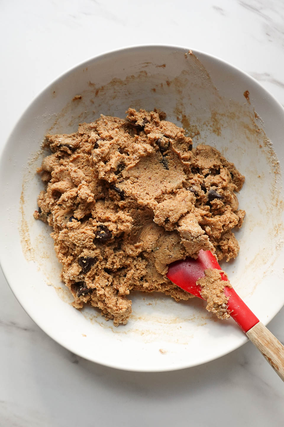 mixing dough for vegan chocolate chip cookies