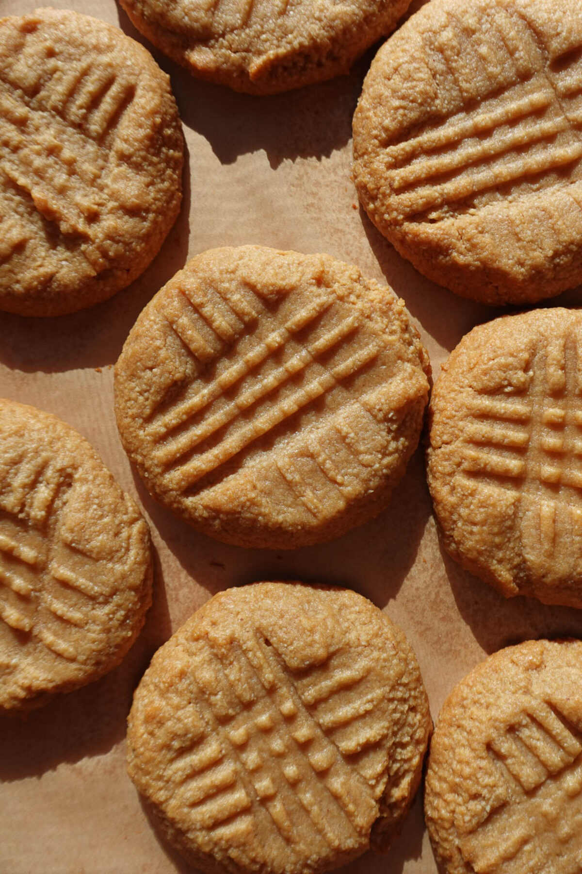 3 ingredient peanut butter cookies on a baking sheet, soft and chewy.