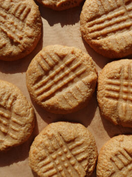 3 ingredient peanut butter cookies on a baking sheet after baking.