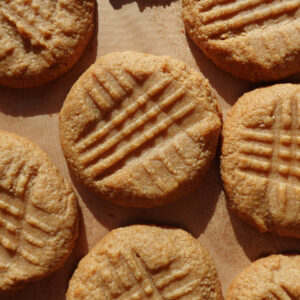 3 ingredient peanut butter cookies on a baking sheet after baking.
