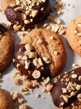 Close-up of chewy peanut butter cookies dipped in chocolate and coated with peanuts