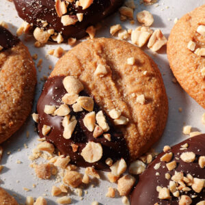 Close-up of chewy peanut butter cookies dipped in chocolate and coated with peanuts
