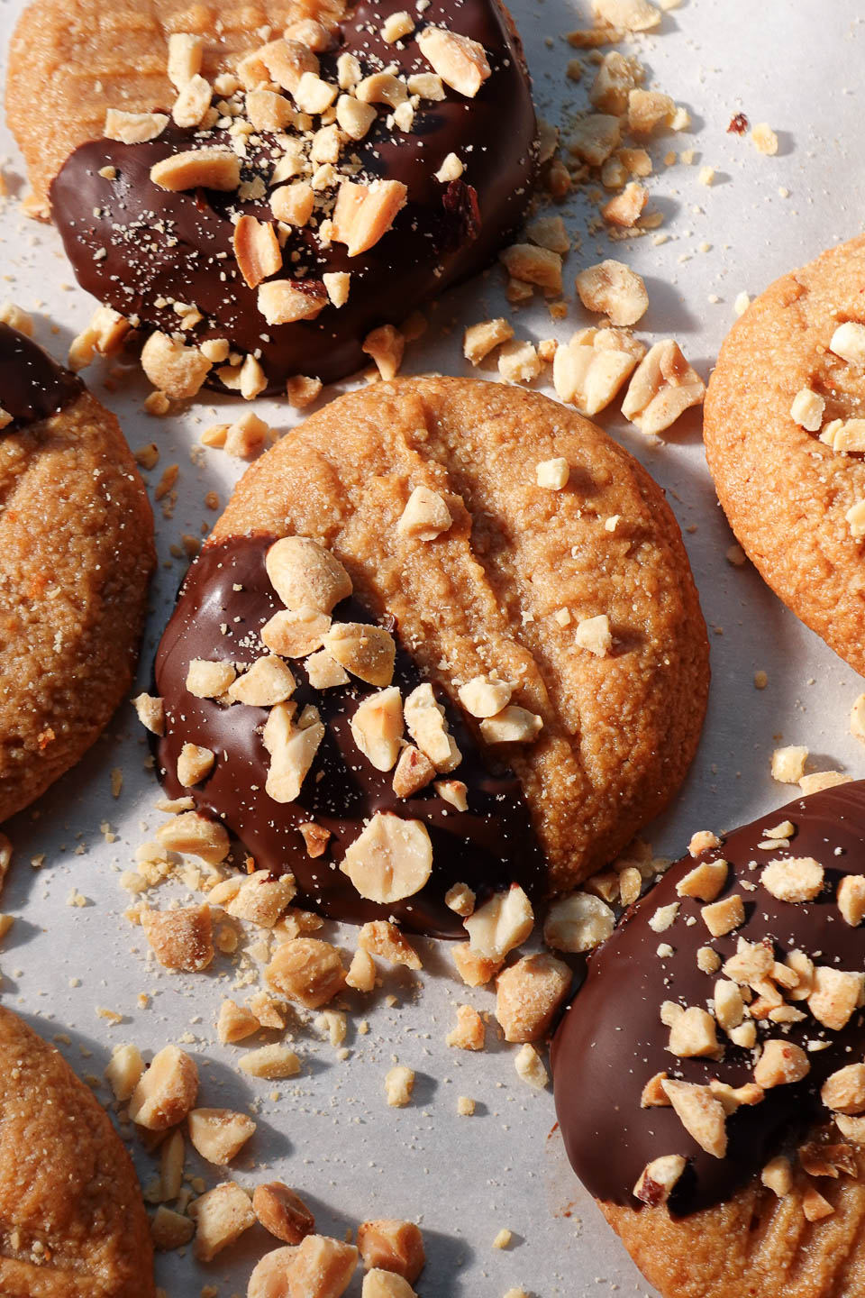Close-up of chewy peanut butter cookies dipped in chocolate and coated with peanuts