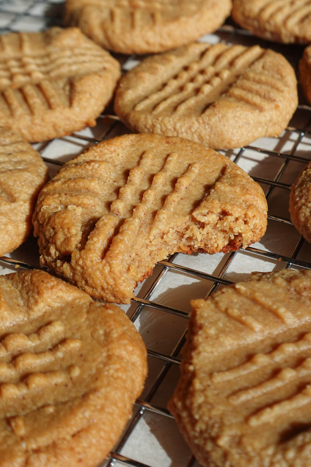 easy peanut butter cookies made with just 3 ingredients with a bite taken out showing it's soft and chewy texture