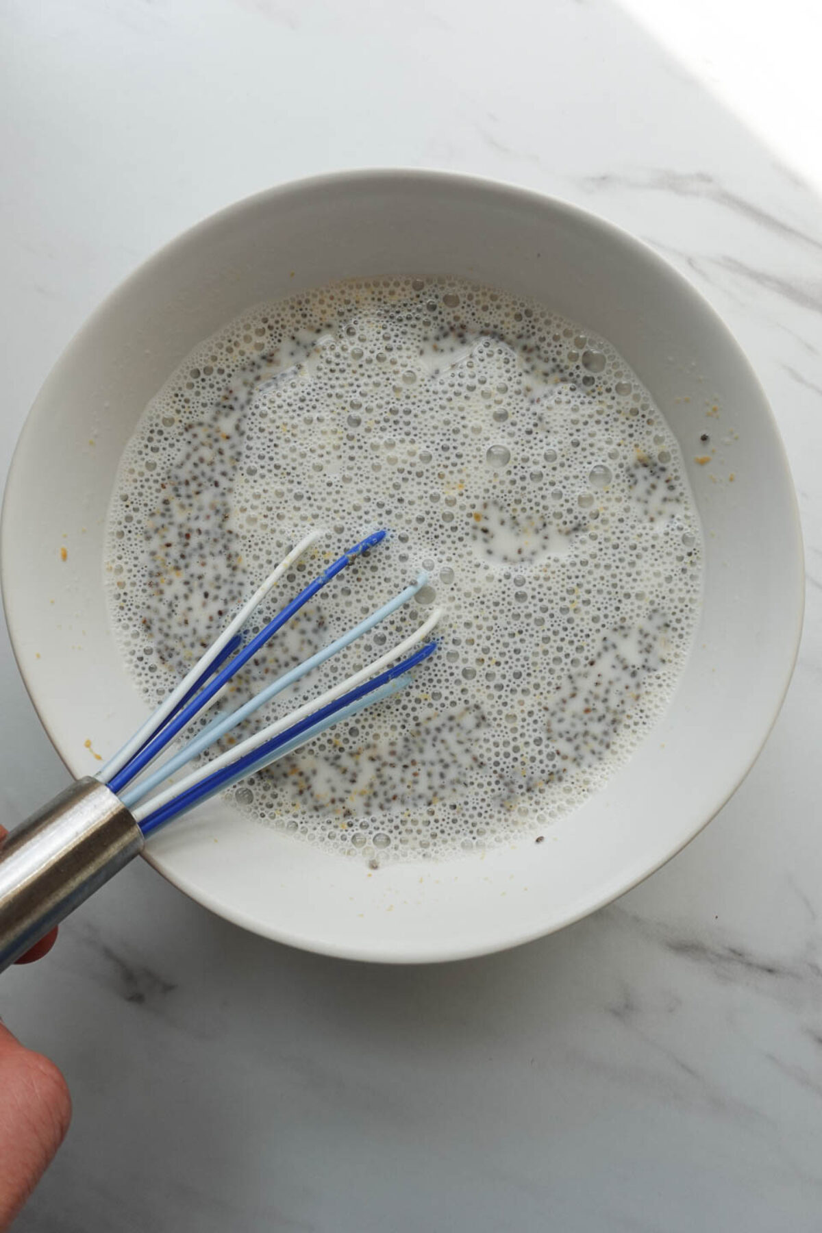 whisking chia seeds, peanut butter, maple syrup, vanilla extract, and non-dairy milk to make peanut butter chia pudding layer