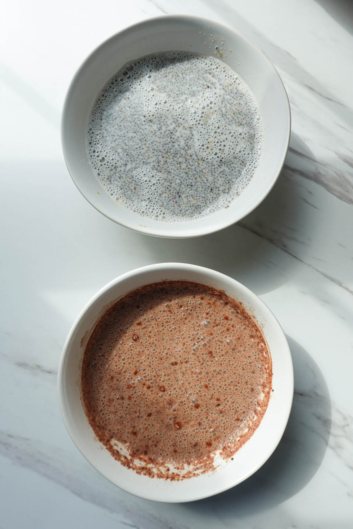 bowl of chocolate chia pudding and peanut butter chia pudding before chilling overnight