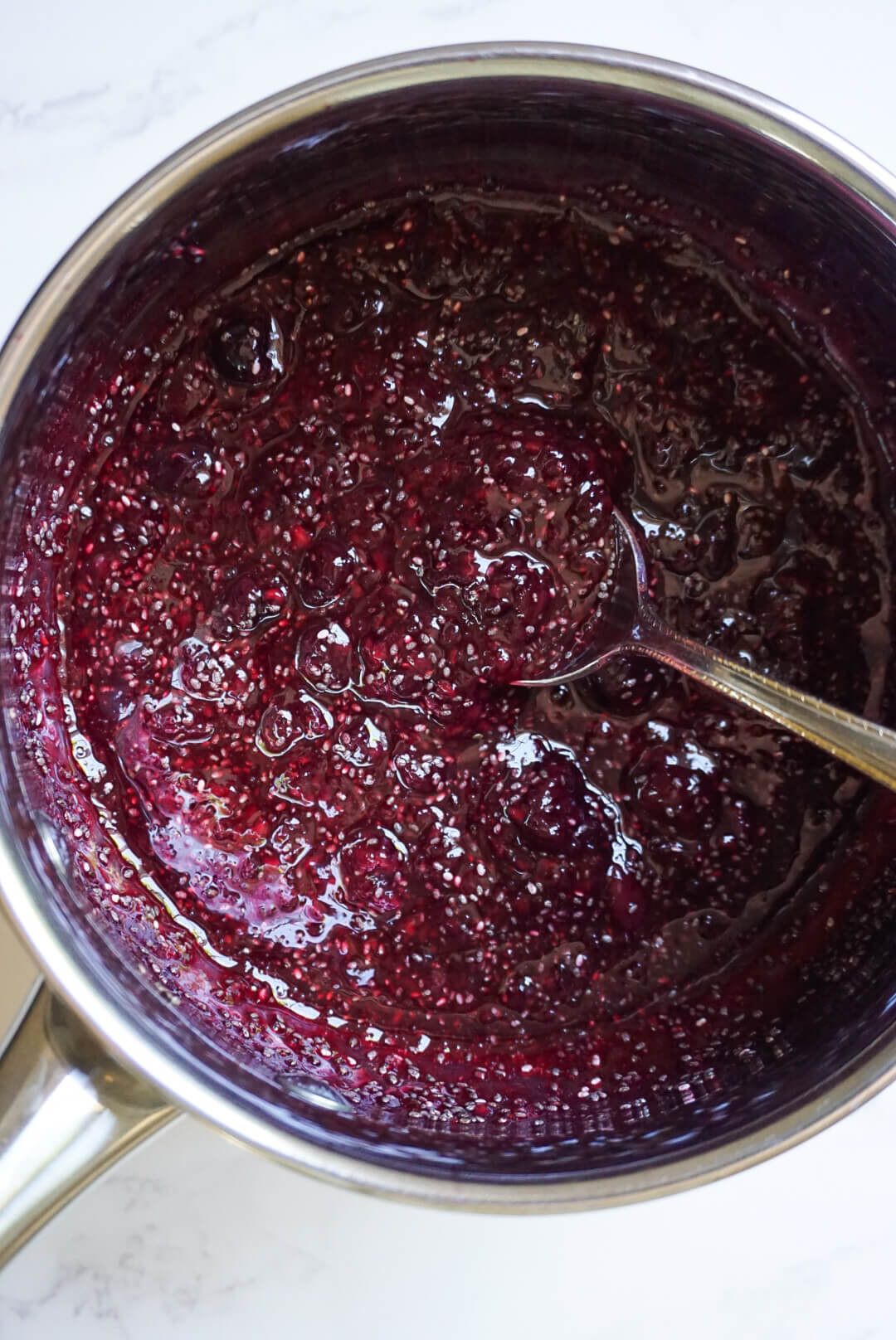 chia seeds and fruit in a pot to make chia jam