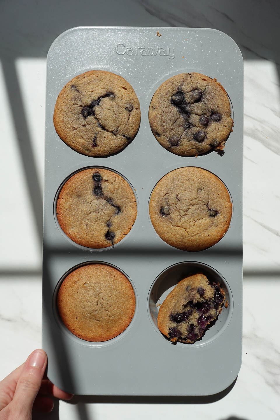 vegan blueberry muffins in muffin pan after being baked