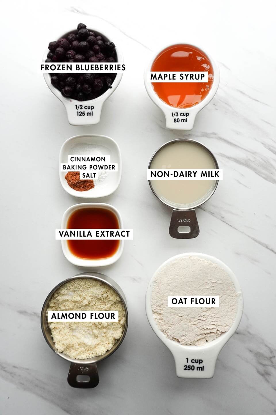 Ingredients for healthy blueberry muffins including oat flour almond flour and blueberries