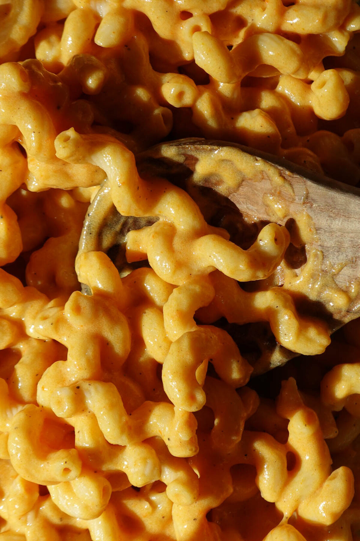 Healthy vegan mac and cheese with hidden vegetables, topped with pepper for added flavor