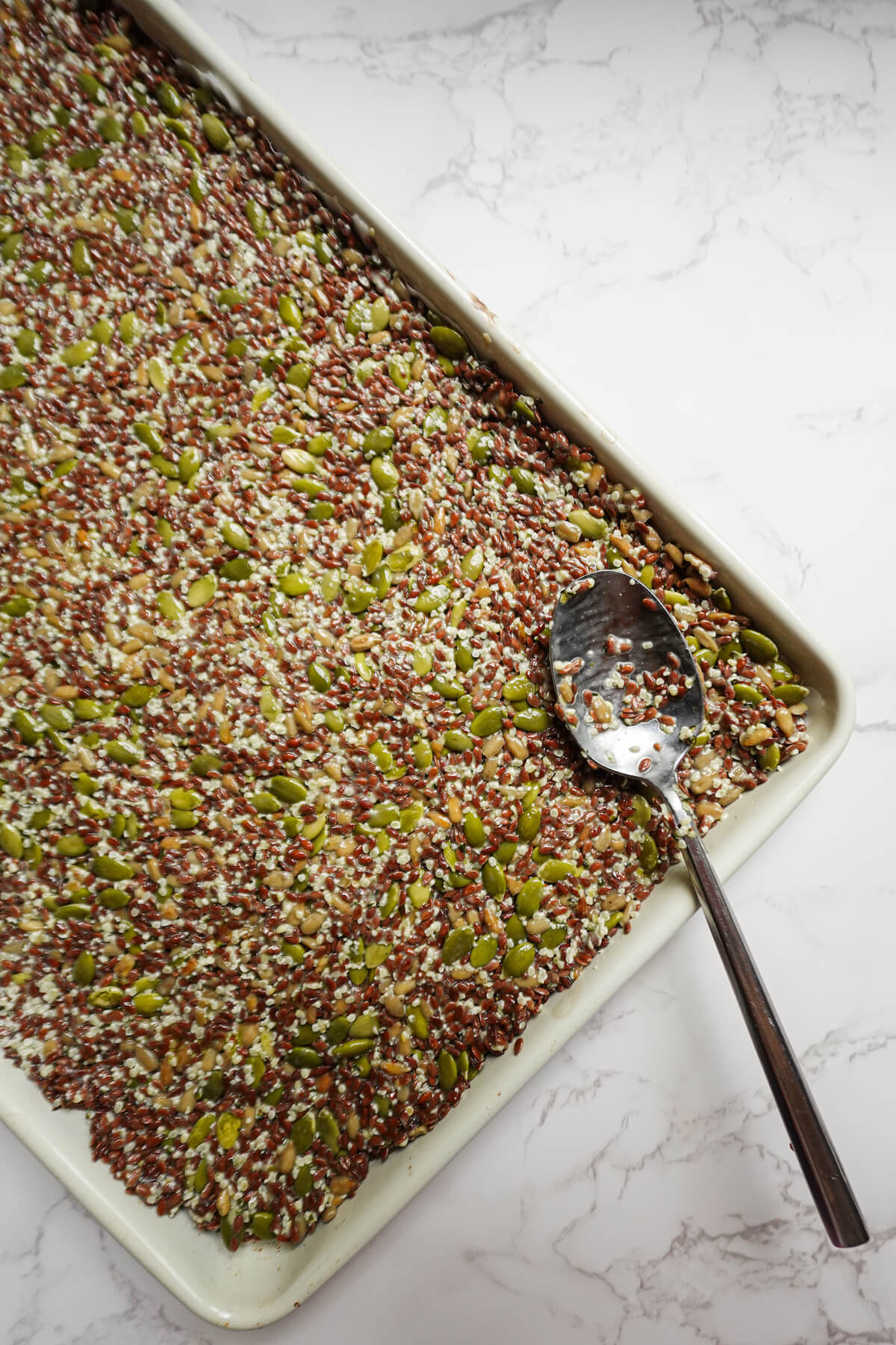 spreading flax seed cracker mixture in a pan