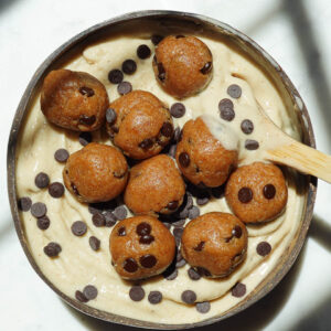 Vegan cookie dough nice cream served in a bowl with chocolate chips and cookie dough pieces on top