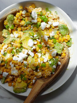 Vegan Mexican street corn salad with avocado, vegan feta, jalapeños, and lime.