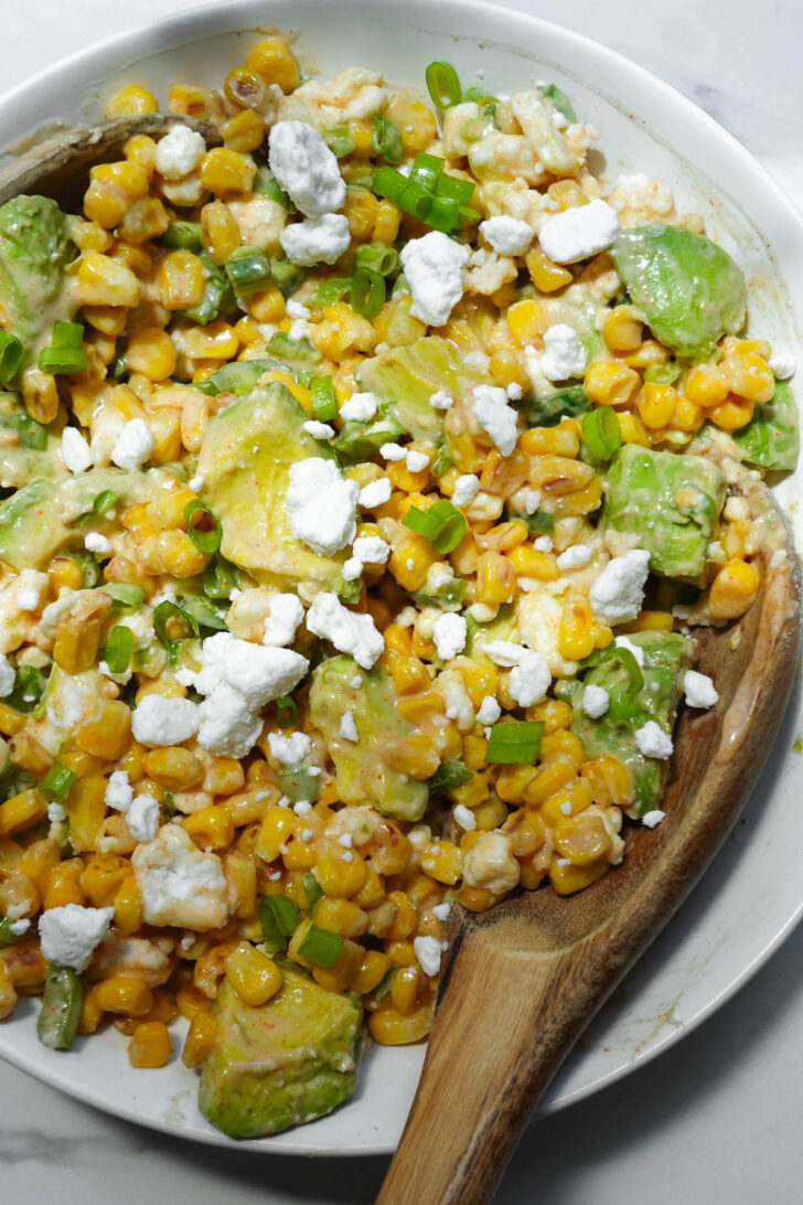 Vegan elote salad made with fresh summer corn, avocado, and vegan feta.