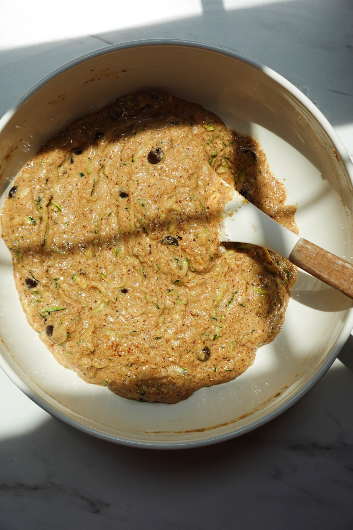 Zucchini muffin batter fully mixed together.